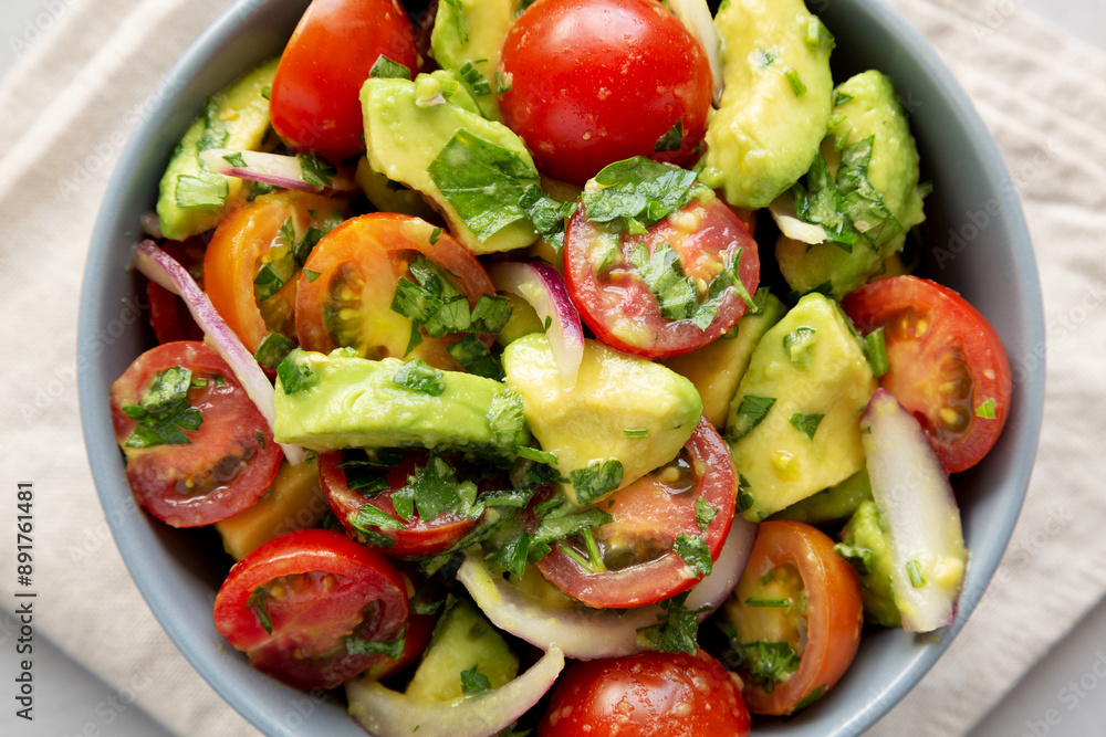 Homemade Avocado And Tomato Salad in a Bowl, top view. Homemade Avocado And Tomato Salad in a Bowl, top view.