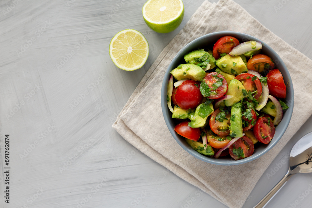 Homemade Avocado And Tomato Salad in a Bowl, top view. Flat lay, overhead, from above. Homemade Avocado And Tomato Salad in a Bowl, top view. Flat lay, overhead, from above.