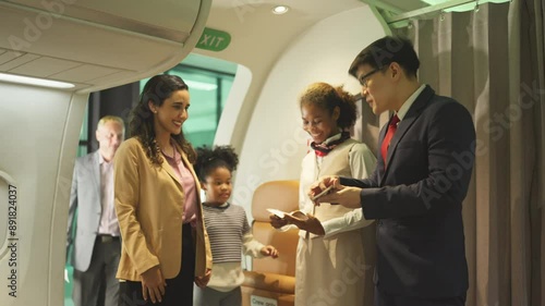 Air hostess man and woman stand in front of gate of airplane to welcome and service the customers before take of from airport.