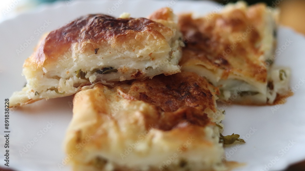Homemade Turkish Börek Slices on a White Plate Homemade Turkish Börek Slices on a White Plate