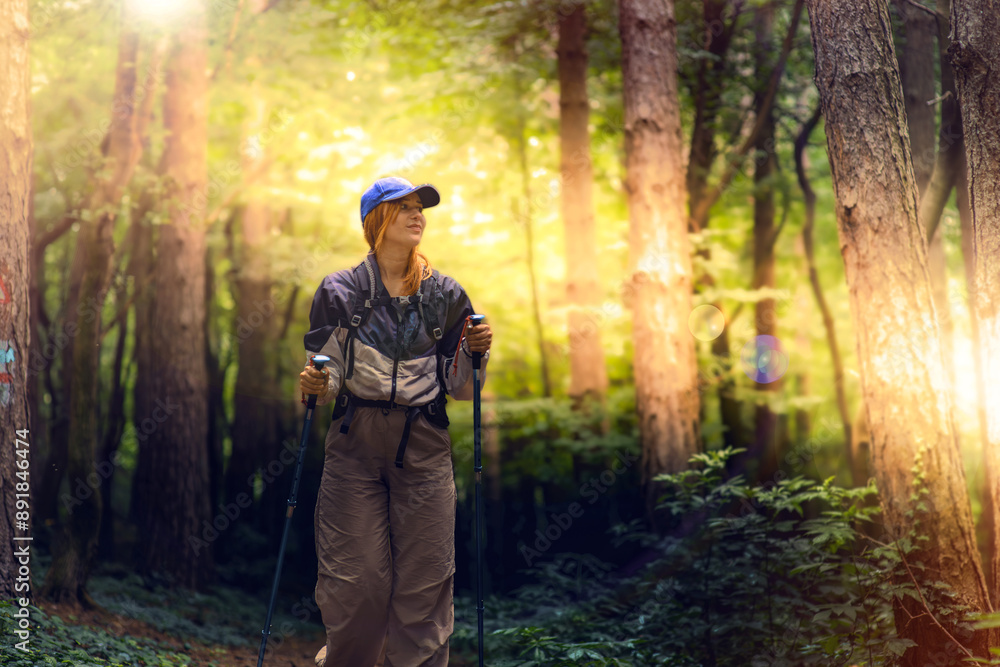 Obraz premium Beautiful young women with big backpack hiking in the deep forest