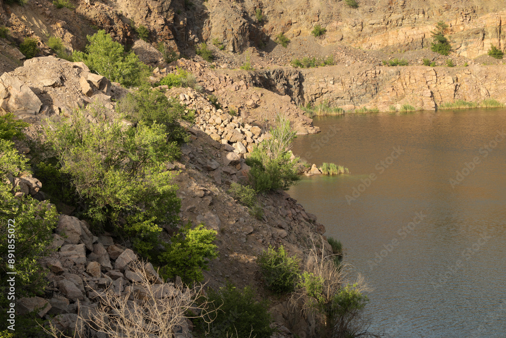 Rocky shore of a quarry lake Rocky shore of a quarry lake