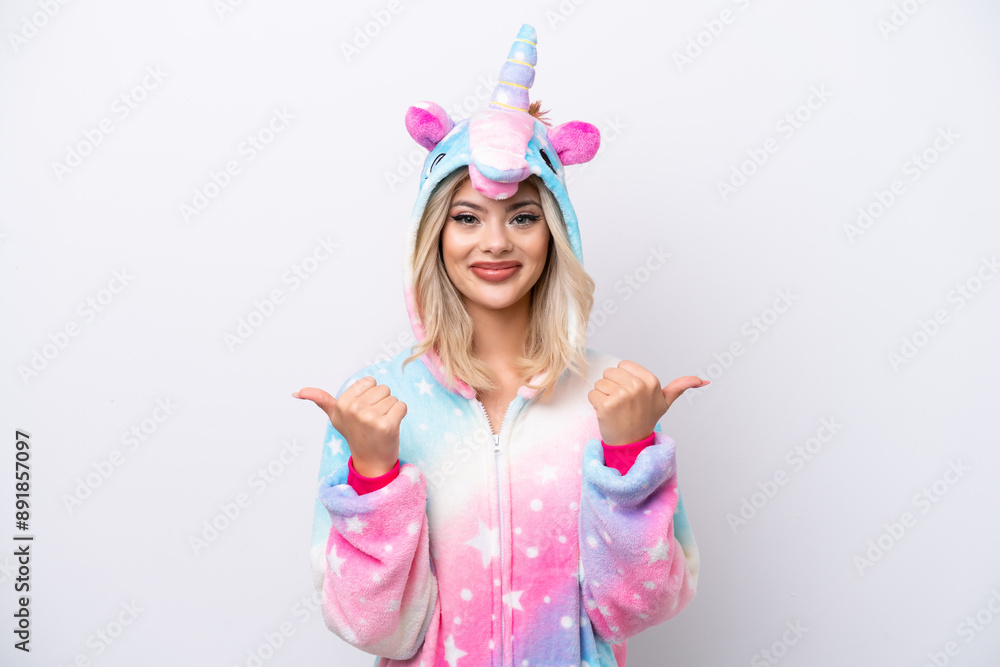 Young Russian woman with unicorn pajamas isolated on white background with thumbs up gesture and smiling Young Russian woman with unicorn pajamas isolated on white background with thumbs up gesture and smiling