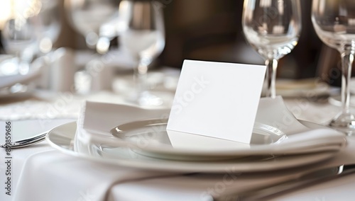 Photo of a blank place card on an elegant table setting for a wedding.