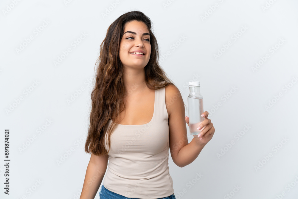Young caucasian woman with a bottle of water isolated on white background laughing Young caucasian woman with a bottle of water isolated on white background laughing