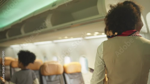 Air hostess stand in front of gate of airplane to welcome and service the customers before take of from airport.