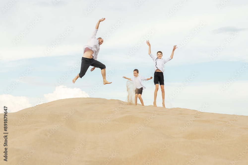 Joyful Family Leaping on Sandy Dune: Father and Sons Embracing Freedom and Adventure During Beach Vacation Joyful Family Leaping on Sandy Dune: Father and Sons Embracing Freedom and Adventure During Beach Vacation