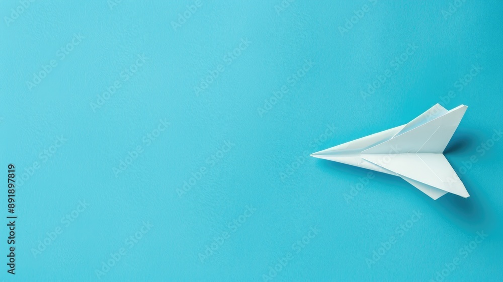 White paper airplane on blue background White paper airplane on blue background