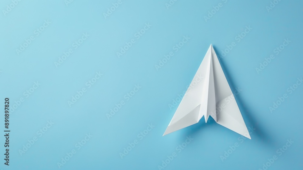 White paper airplane on blue background White paper airplane on blue background