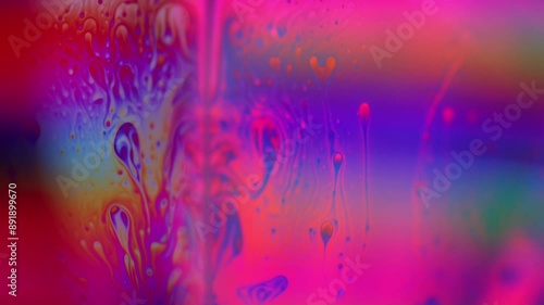 Pink liquid, bubble in macro, movement of liquid in a bubble, green absorption, chaotic movement, silver fluid structure photo