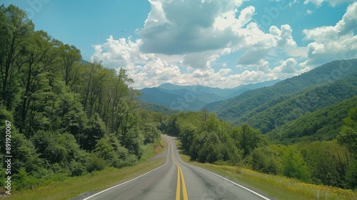 Journey down a scenic highway towards the Great Smoky Mountains National Park, Tennessee, surrounded by lush, green landscapes