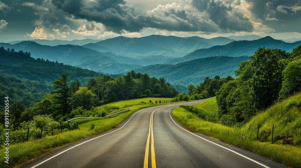 Naklejka premium Scenic drive towards the Great Smoky Mountains National Park, Tennessee, showcasing a long road through rich green landscapes