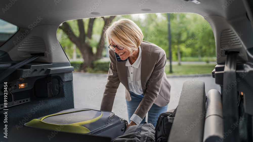 © Miljan Živković - mature blonde woman travel take stuff belongings from the back of car © Miljan Živković - mature blonde woman travel take stuff belongings from the back of car