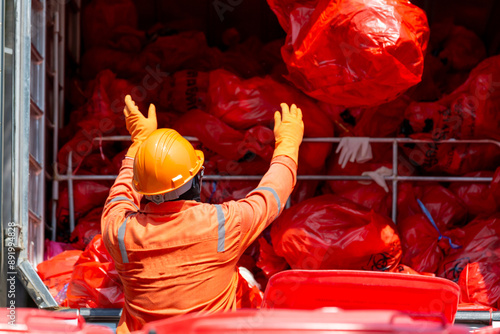 Fotografija Asian man worker wear protective Infectious waste, Red garbage waste disposal infectious waste garbage red garbage bag, Logistics control infectious waste hospital