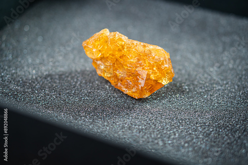 Amber Crystal on Black Surface