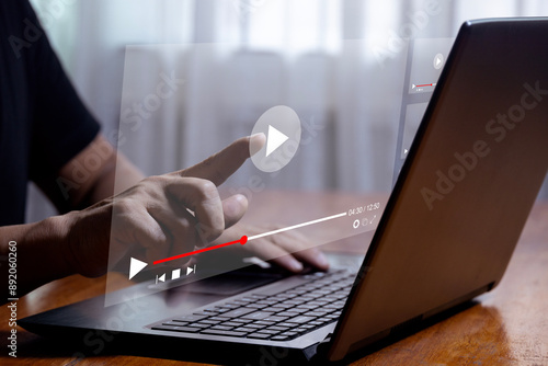Man using laptop to stream online on virtual screen Streaming video on internet concept Watch videos on the internet, live concerts, performances or tutorials. online business content