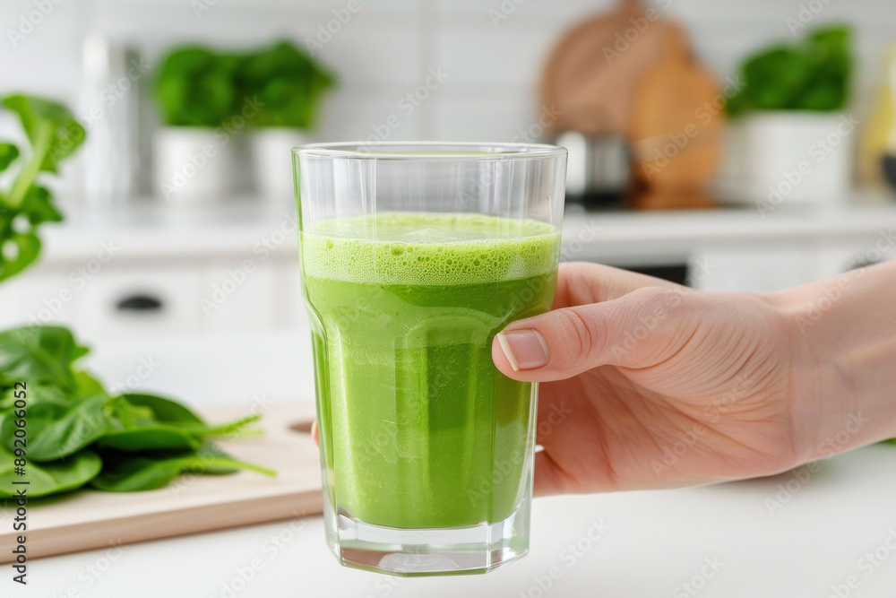 A hand hold A glass of spinach vegetable juice, healthy drink vegan food A hand hold A glass of spinach vegetable juice, healthy drink vegan food