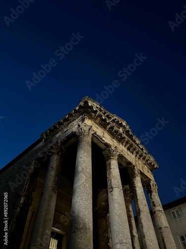 Nighttime view of the Maison Carree, an ancient Roman temple in Nimes, France. photo