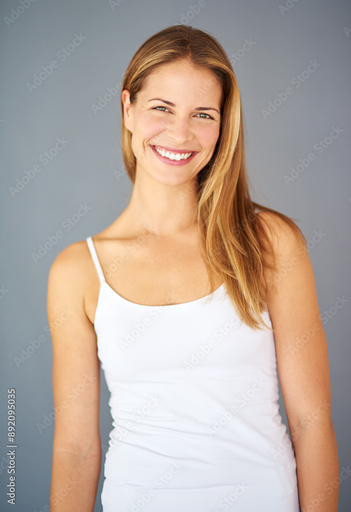 Model, portrait and smile with cosmetics, beauty and hairstyle for hair care and glow. Woman, natural confidence or keratin treatment for salon, shine and aesthetic isolated on gray studio background Model, portrait and smile with cosmetics, beauty and hairstyle for hair care and glow. Woman, natural confidence or keratin treatment for salon, shine and aesthetic isolated on gray studio background