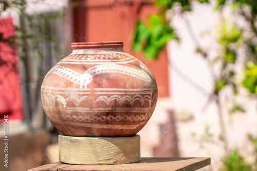 Traditional Earthen Pot in Sunny Outdoor Setting