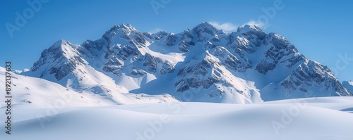 Snow-covered mountain peaks under a clear blue sky, pristine and majestic, perfect for winter and nature themes, copy space.