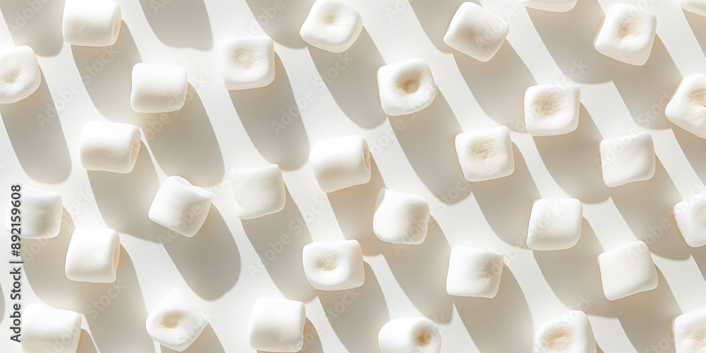 Obraz premium A background of marshmallows, each with its shadow, scattered across the canvas in an elegant display, with soft shadows on a white background