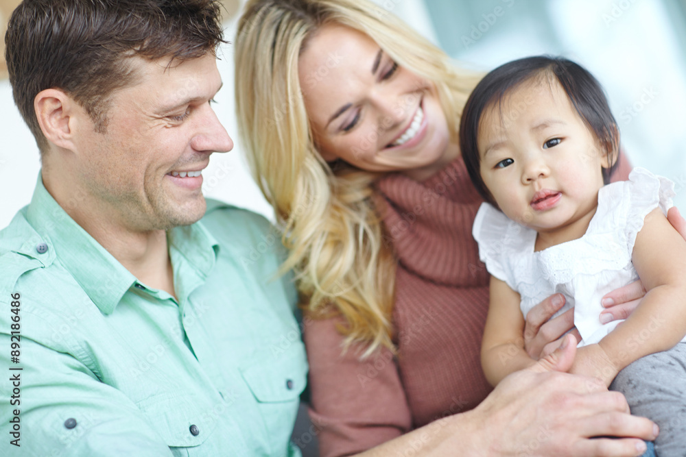 Happy family, parents and portrait of adopted baby child in home for custody, support and bonding together. Mother, father and face of cute foster kid for connection, diversity and interracial care Happy family, parents and portrait of adopted baby child in home for custody, support and bonding together. Mother, father and face of cute foster kid for connection, diversity and interracial care