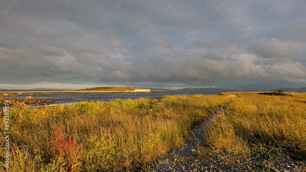 Dramatic coastal sunset landscape scenery with cliffs in background, sandy Silverstrand beach, Galway, Ireland, nature wallpaper