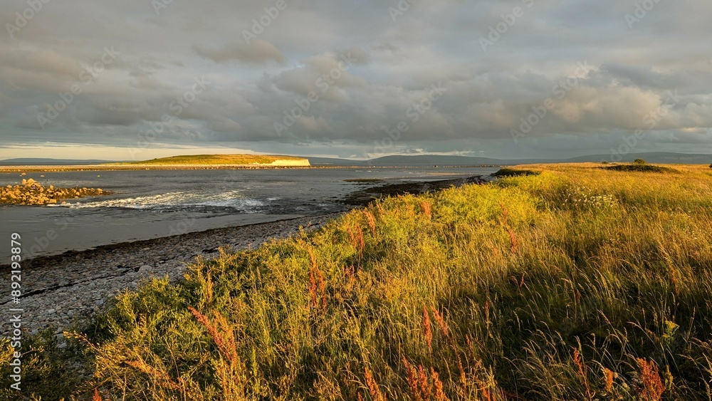 Dramatic coastal sunset landscape scenery with cliffs in background, sandy Silverstrand beach, Galway, Ireland, nature wallpaper