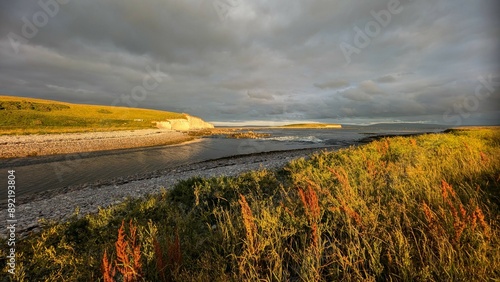 Dramatic coastal sunset landscape scenery with cliffs in background, sandy Silverstrand beach, Galway, Ireland, nature wallpaper