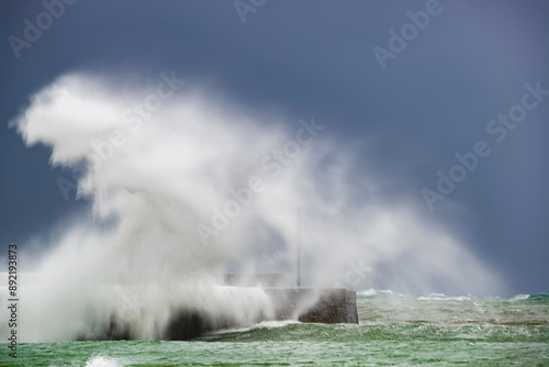 Tableau sur toile Large wave impacts the breakwater of Plentzia beach, Bizkaia during a storm in t