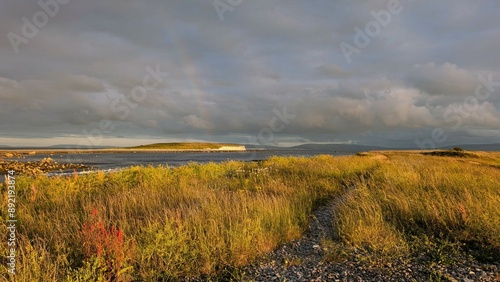 Obraz na płótnie Dramatic coastal sunset landscape scenery with cliffs in background, sandy Silverstrand beach, Galway, Ireland, nature wallpaper w salonie