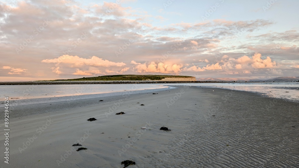 Dramatic coastal sunset landscape scenery with cliffs in background, sandy Silverstrand beach, Galway, Ireland, nature wallpaper