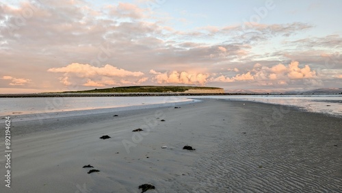 Obraz na płótnie Dramatic coastal sunset landscape scenery with cliffs in background, sandy Silverstrand beach, Galway, Ireland, nature wallpaper w salonie