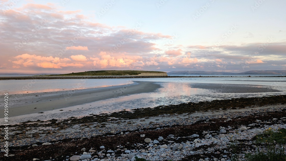 Dramatic coastal sunset landscape scenery with cliffs in background, sandy Silverstrand beach, Galway, Ireland, nature wallpaper