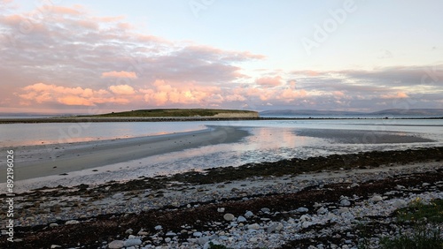 Obraz na płótnie Dramatic coastal sunset landscape scenery with cliffs in background, sandy Silverstrand beach, Galway, Ireland, nature wallpaper w salonie