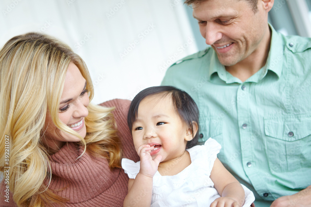 Smile, family and foster baby in home for love, support or bonding together. Mother, father and cute adopted kid with parents for connection, interracial or playing with child for care in living room Smile, family and foster baby in home for love, support or bonding together. Mother, father and cute adopted kid with parents for connection, interracial or playing with child for care in living room
