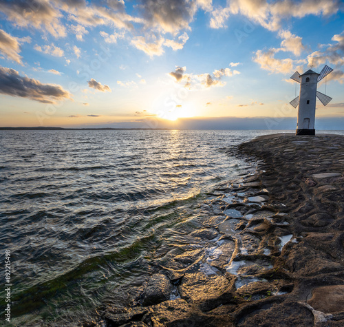 Obraz na płótnie old windmill in Swinoujscie over Baltic sea during sunset in Poland w salonie