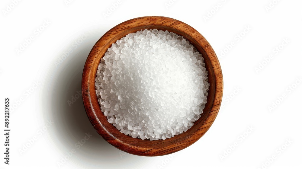Top view of sea salt in a rustic wooden bowl on white background. Simple and elegant food styling. Top view of sea salt in a rustic wooden bowl on white background. Simple and elegant food styling.