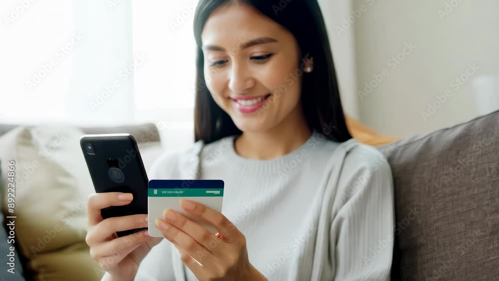 Happy Woman Using Phone and Credit Card for Online Shopping Happy Woman Using Phone and Credit Card for Online Shopping