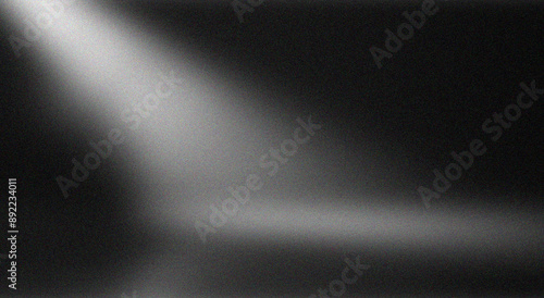 Abstract background black with a gradient of light and shadow, a dark gray, glowing grainy color, noise texture effect