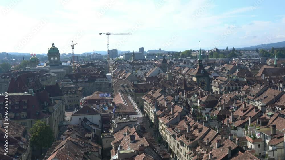 A cityscape with many buildings and a few trees. The sky is blue and the sun is shining A cityscape with many buildings and a few trees. The sky is blue and the sun is shining