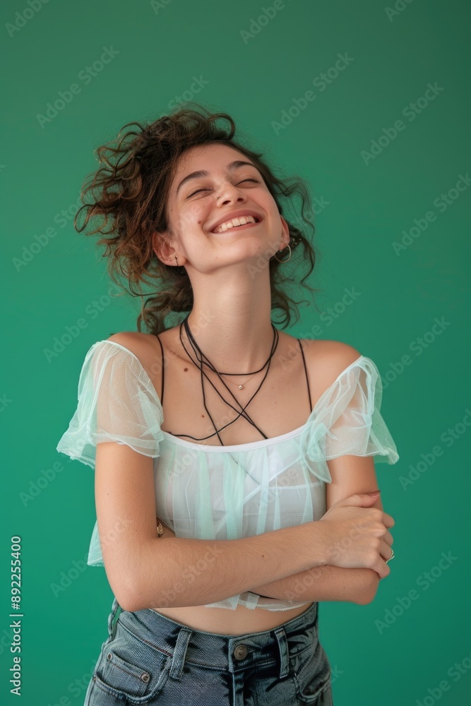 A happy woman standing with her arms crossed and a smile on her face A happy woman standing with her arms crossed and a smile on her face
