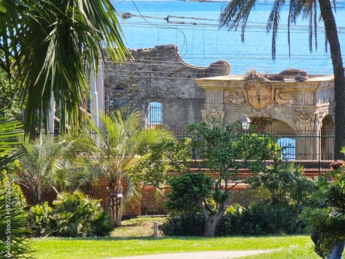 Genova, Italy, April 19, 2024. Scenic views of Genova Nervi from the coastal promenade, Liguria, Italy. Beautiful sunny day with blue sky reflected over the sea. Mediterranean rocky coastline village