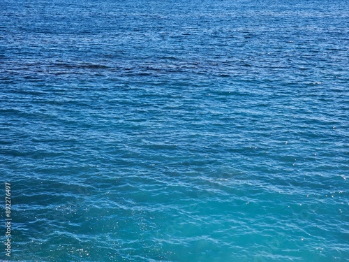 Genova, Italy, April 19, 2024. Scenic views of Genova Nervi from the coastal promenade, Liguria, Italy. Beautiful sunny day with blue sky reflected over the sea. Mediterranean rocky coastline village