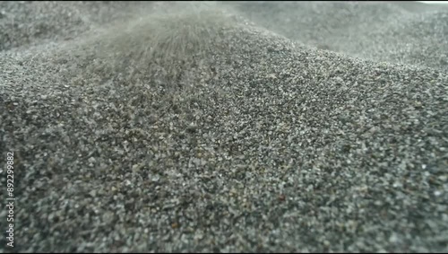 Close-up of black sand grains on a beach showcasing natural texture and detail 