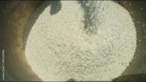 Milled rice grains, rice is poured into buckets for processing. Traditional process. Rice milled  process
