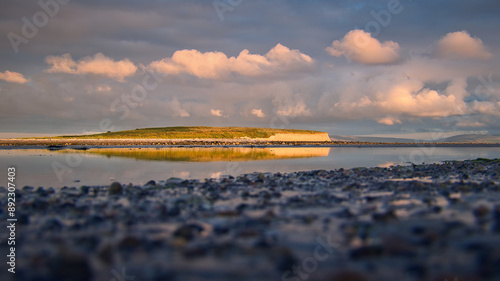 Obraz na płótnie Dramatic coastal sunset landscape scenery with cliffs in background, sandy Silverstrand beach, Galway, Ireland, nature wallpaper w salonie