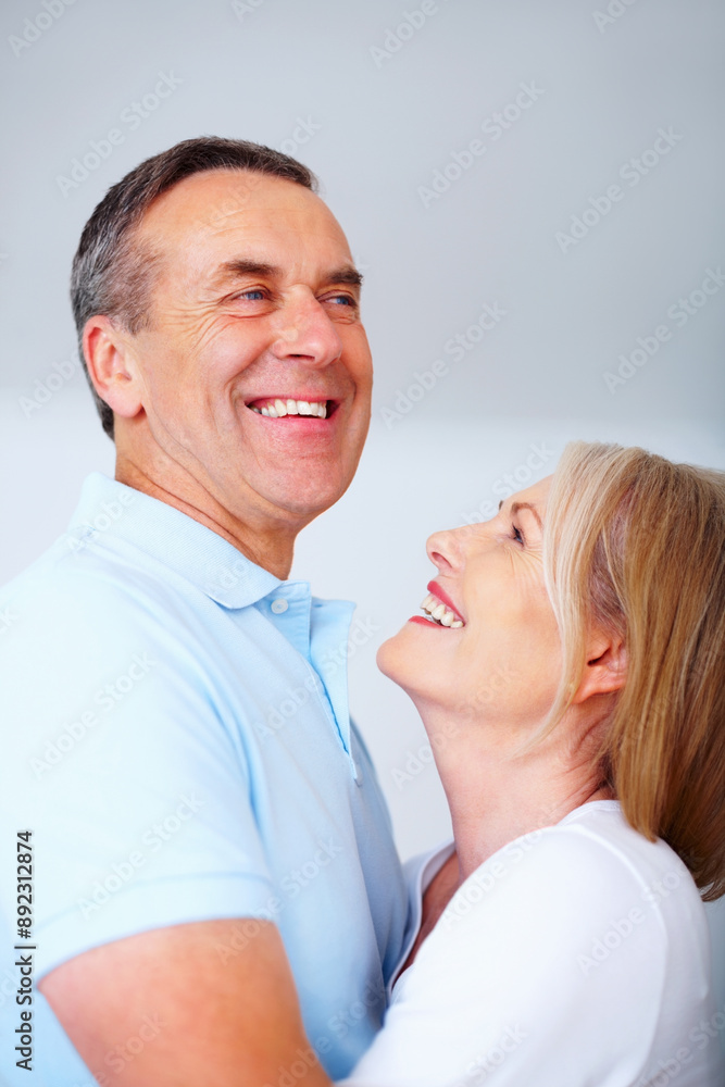 Mature couple, happy and laugh in gray background for love, hug OR embrace as romantic partner. Woman, man and affection for bonding, relationship and together in studio backdrop for health or care Mature couple, happy and laugh in gray background for love, hug OR embrace as romantic partner. Woman, man and affection for bonding, relationship and together in studio backdrop for health or care