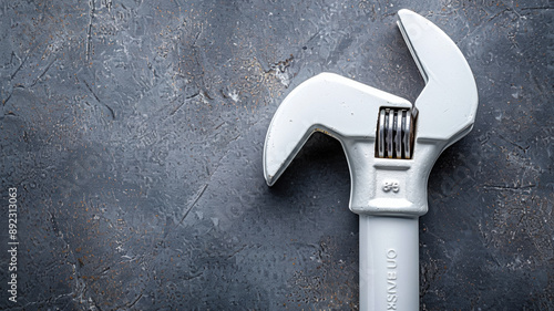 Adjustable metal wrenches with movable jaws and white PVC or CPVC pipes are crucial tools in the plumbing industry for the installation, maintenance, and repair of water and waste systems. photo